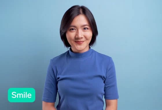 Video of the Emotional Reactions example showing a woman smiling and then laughing with a live prediction in the bottom corner.